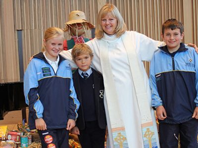 Chaplain and a group of pupils at the Harvest Festival
