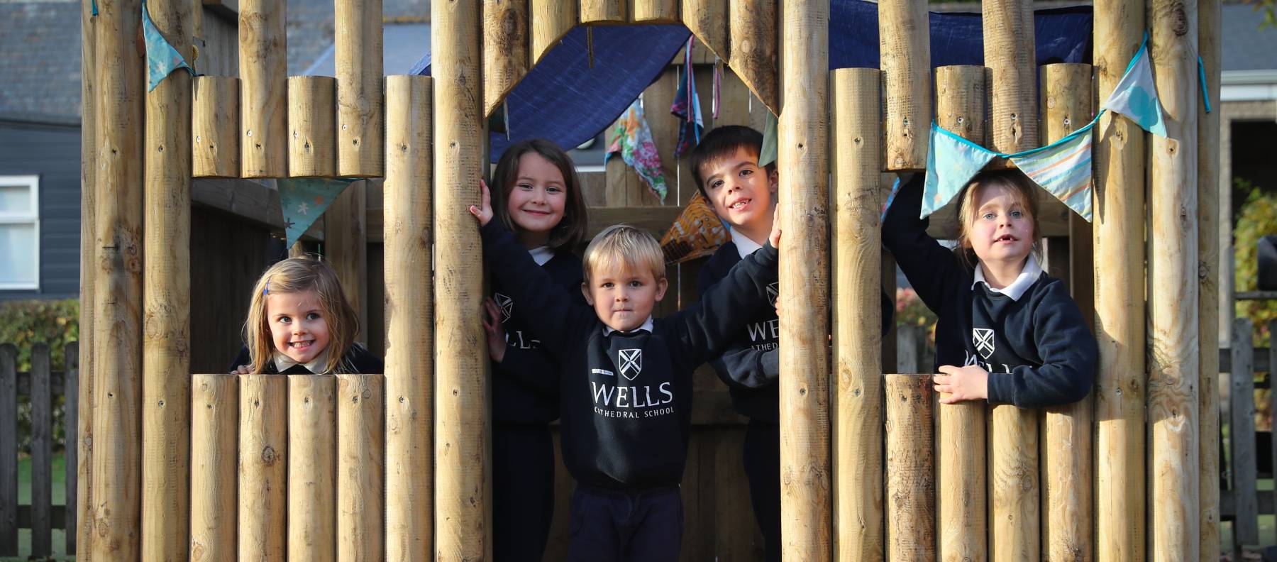 Pre-Prep children playing in wooden fort at our Independent Prep School in Somerset