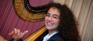Girl playing a harp at our Specialist Music School in England