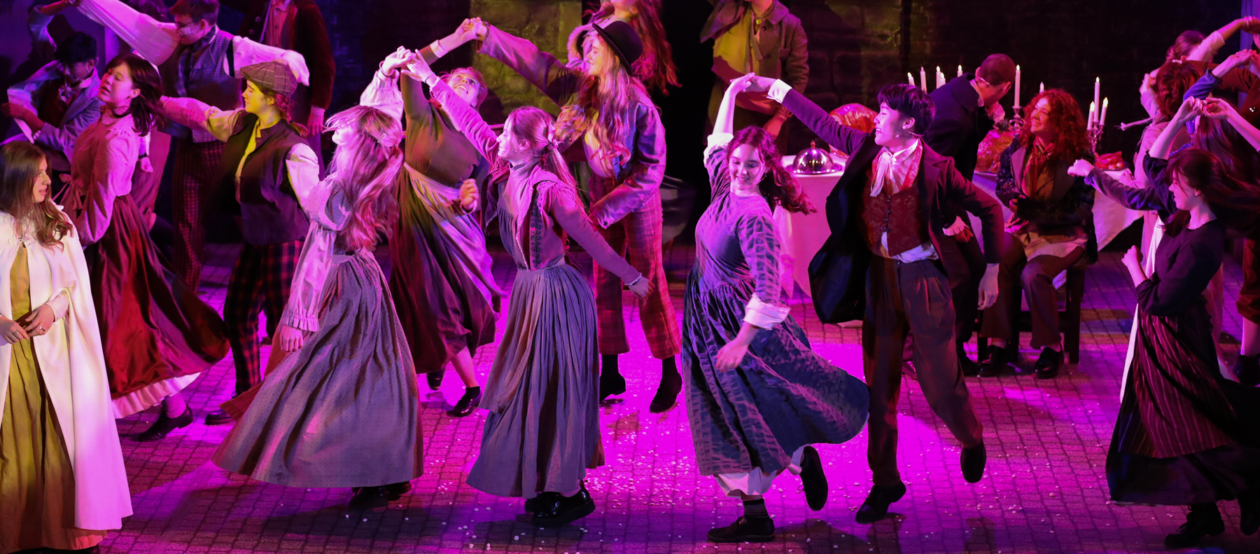 Group dancing in period clothes during production of A Christmas Carol