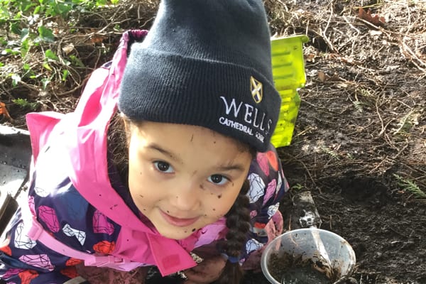 Little girl with Wells hat at Forest School