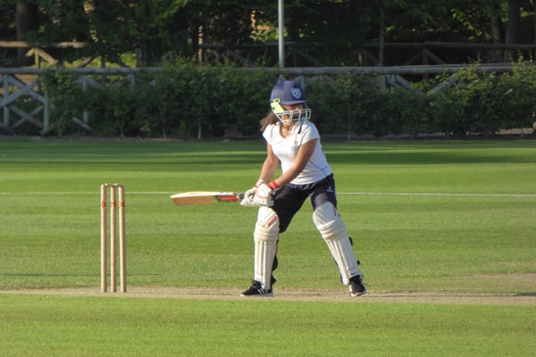Girl playing cricket
