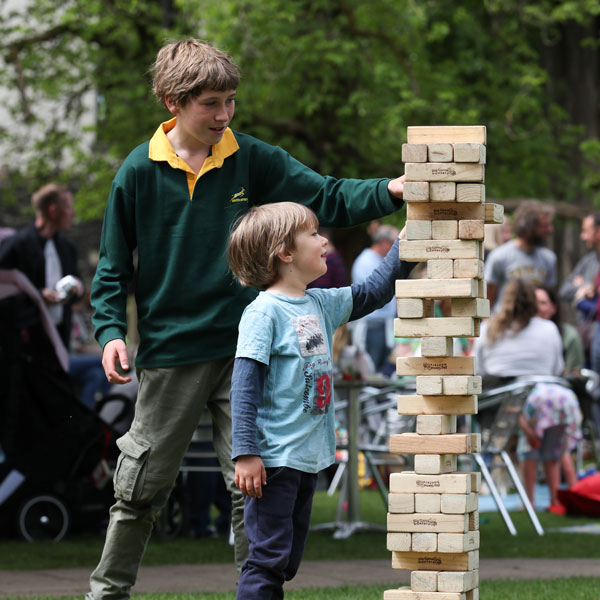 boys playing giant jenga at our Independent Prep School Family Fun Day