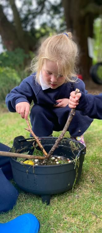 girl with a cauldron outside at our Independent Pre-Prep in Wells Somerset