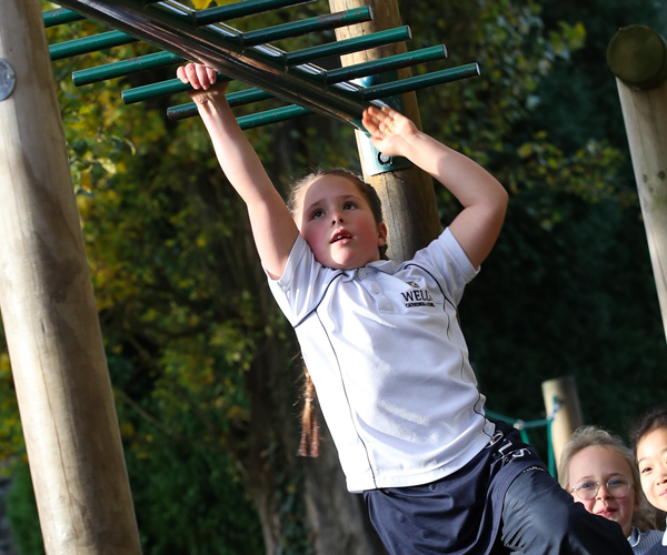 Girl on the monkey bars at the Prep School in Wells, Somerset