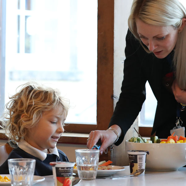 girl and teacher in the dining hall at our Independent Pre-Prep in Wells Somerset