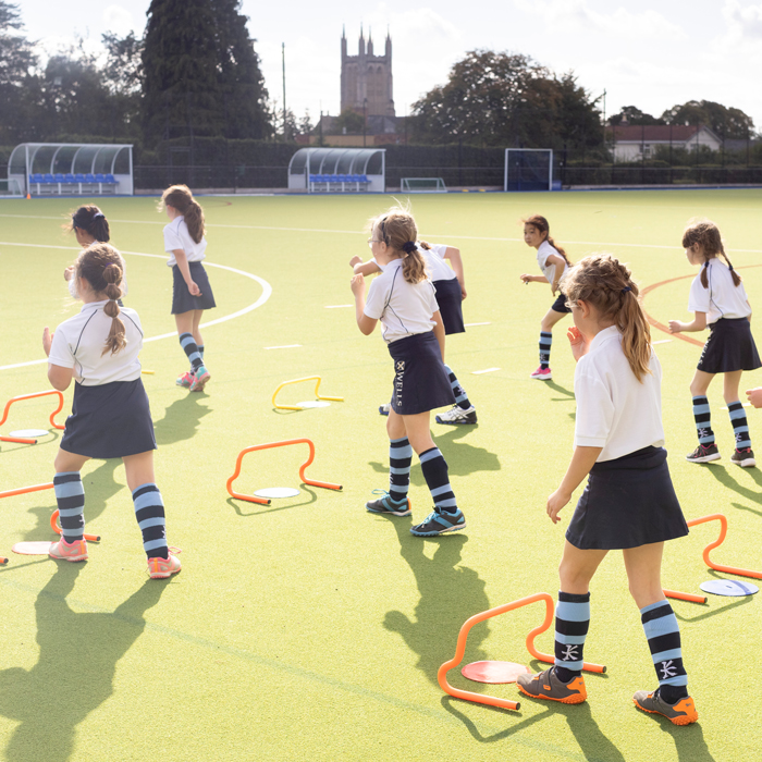 Prep School girls playing hockey at our Independent Prep School in Wells, Somerset