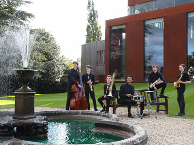 Group of Specialist Musicians sitting outside Cedars Hall by the Fountain in Wells Somerset