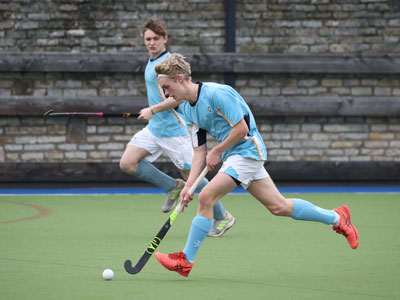 Two teenage boys playing hockey at our independent school in Southwest England
