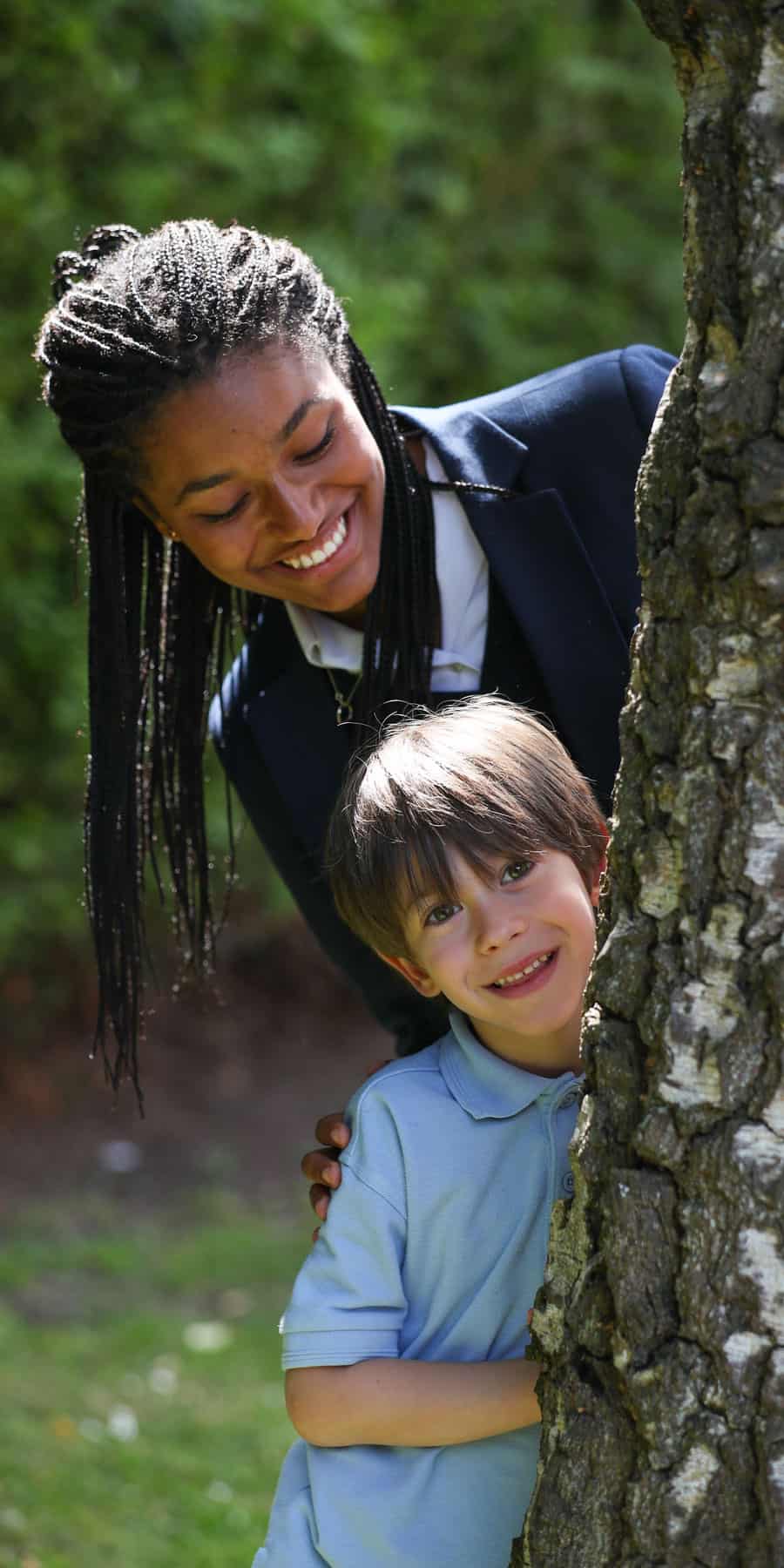 Senior School girl and pre-prep boy by a tree