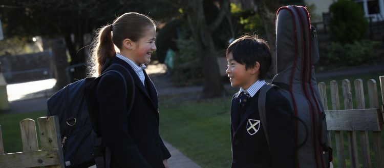 A girl and boy talking outside at Wells Prep School in Somerset, England