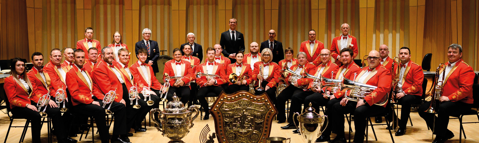 Cory Band in hall with instruments and award