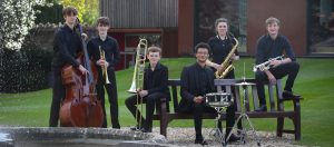 Group of musicians outside a fountain at Cedars Hall in our Specialist Music School