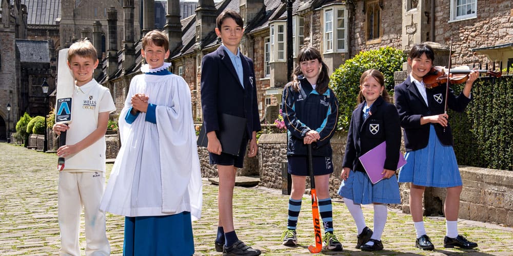 Boys walking down Vicars Close at dusk