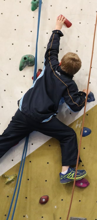 Boy on a climbing wall at our Independent Prep School in Wells, Somerset