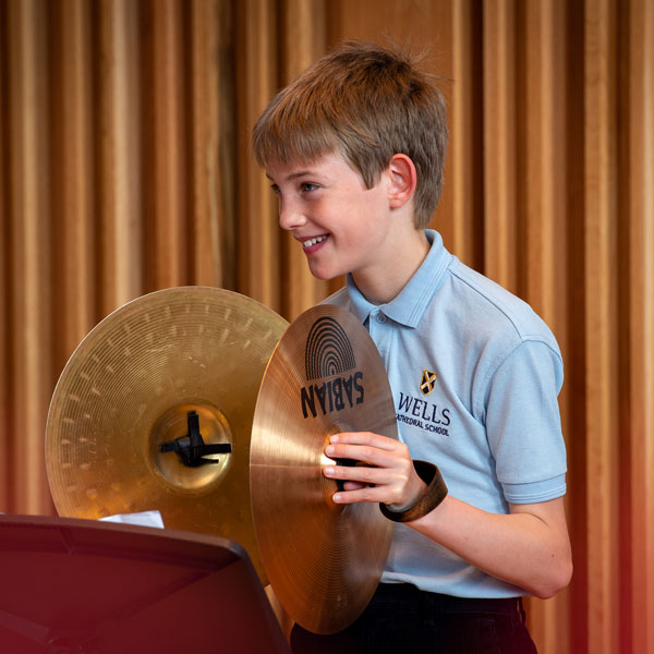 Boy playing cymbals at our Independent Prep School in Wells Somerset
