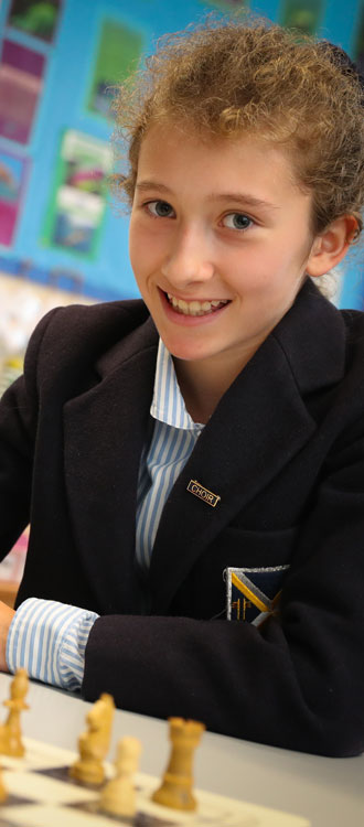 Girl playing chess at our Independent Prep School in Wells, Somerset
