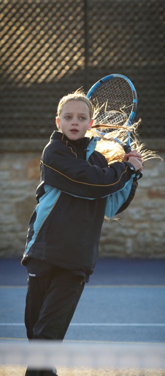 Girl playing tennis at our Independent Prep School in Wells, Somerset