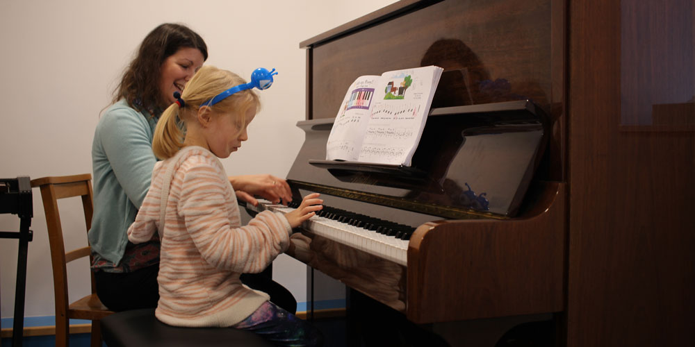 Girl playing piano at our Independent Pre-Prep in Somerset