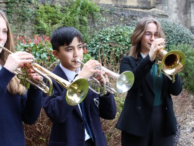 Three pupils playing trumpet at our Specialist Music School in Wells, England