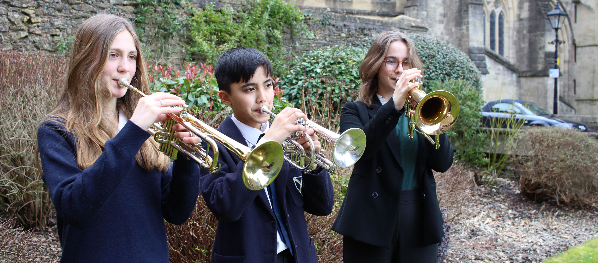 Three pupils playing trumpet at our Specialist Music School in Wells, England