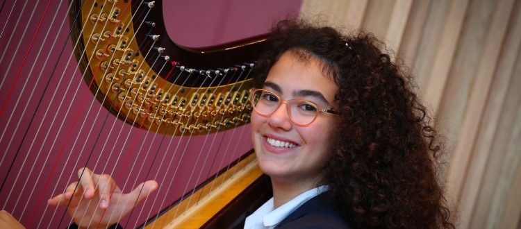 Girl playing harp at our Specialist Music School in Somerset