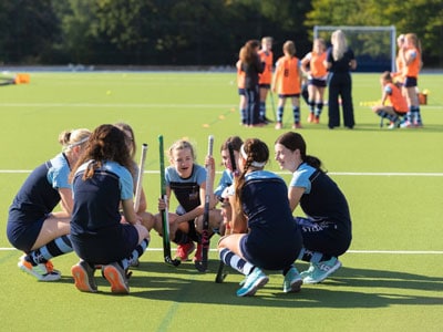Girls playing hockey at our independent school in Wells, Somerset