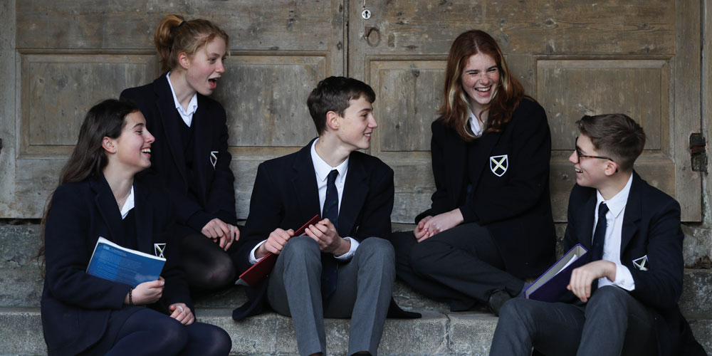Boys walking down Vicars Close at dusk