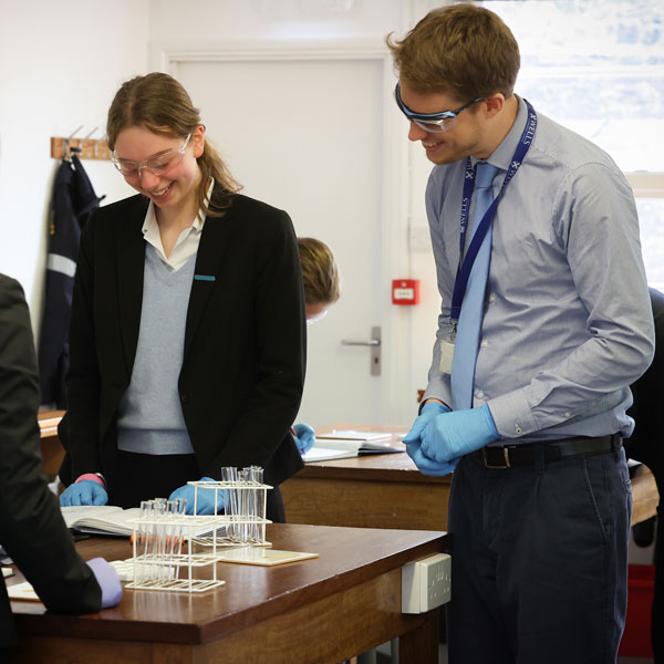 Staff and pupil doing chemistry